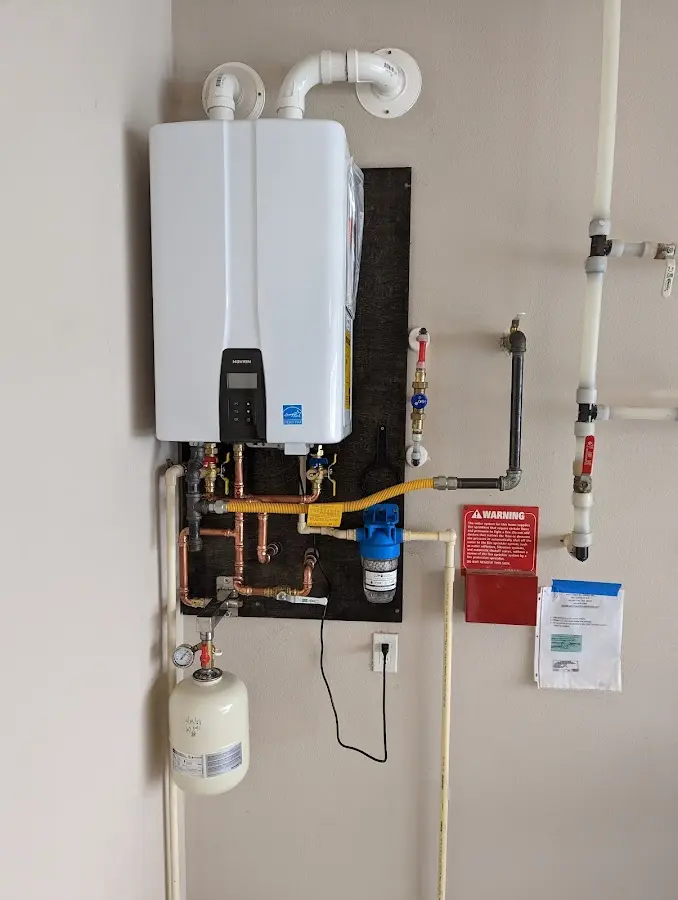 Professional plumber installing copper piping in a Chautauqua home